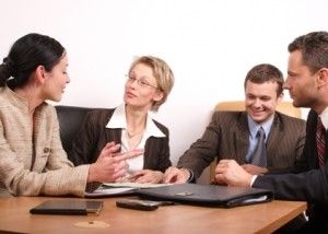 group of people negotiate at the desk